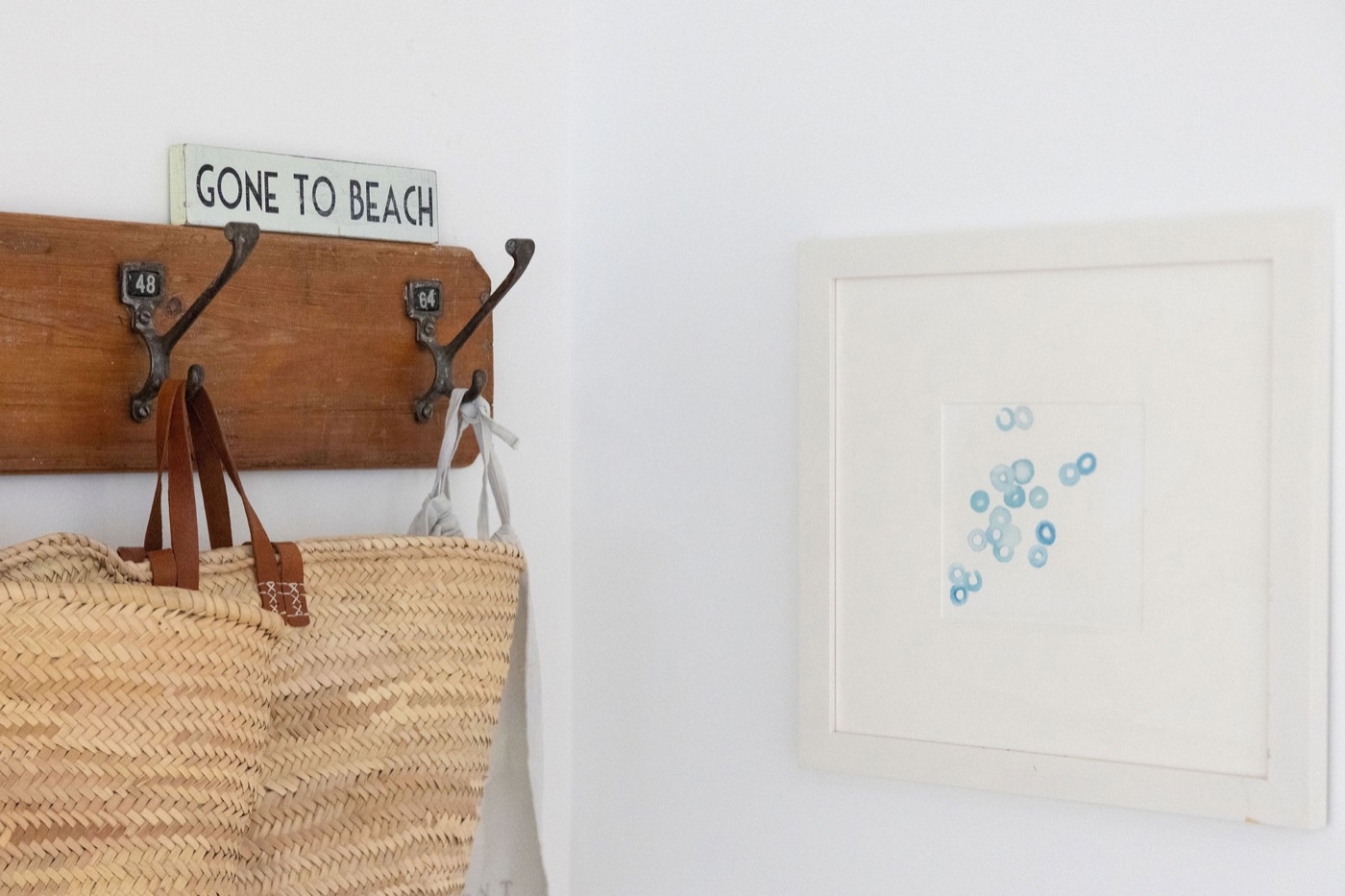 Woven beach bags beneath a Gone to Beach sign