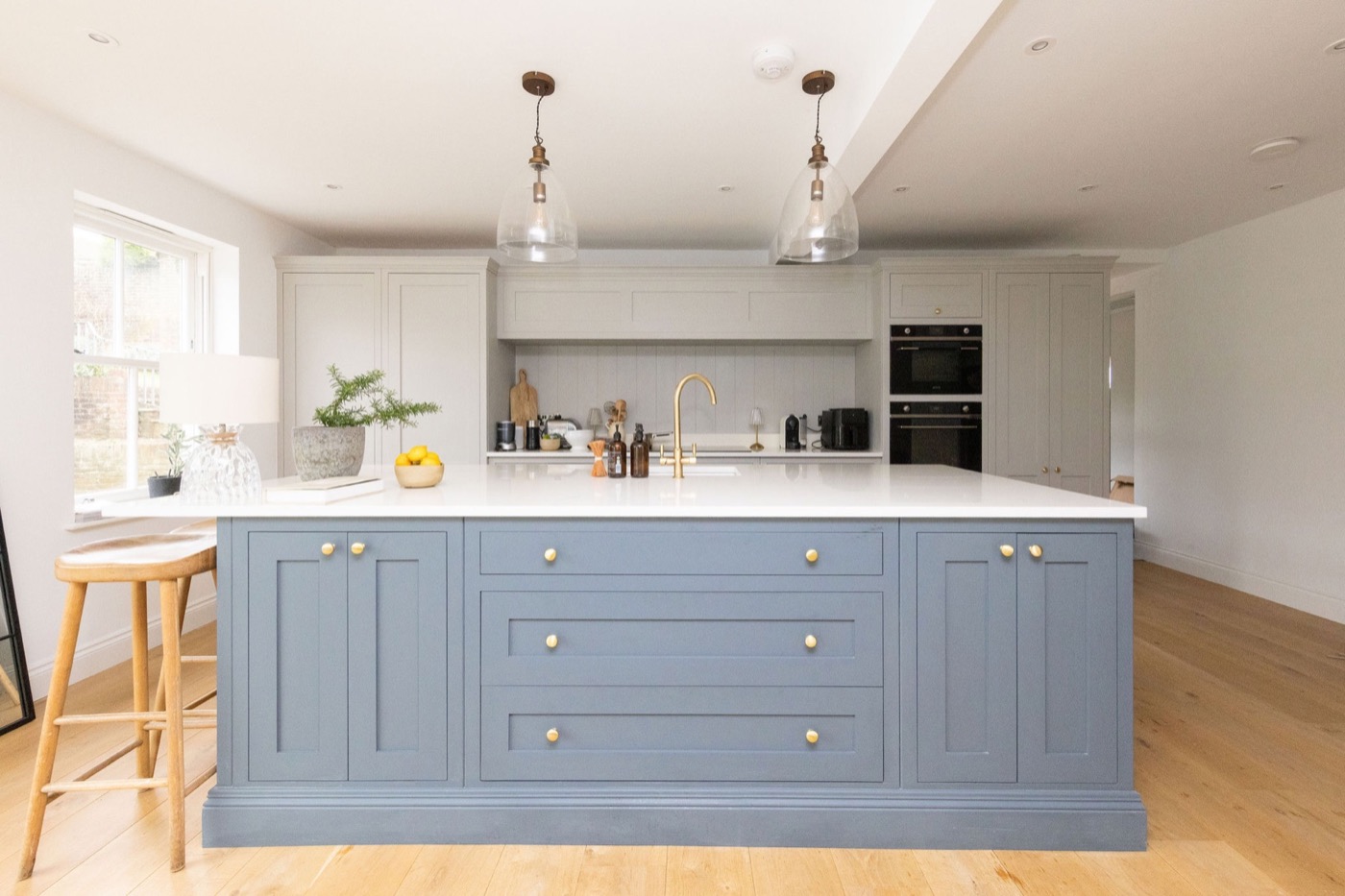 Blue kitchen island with brass fittings at The Lookout Brighton