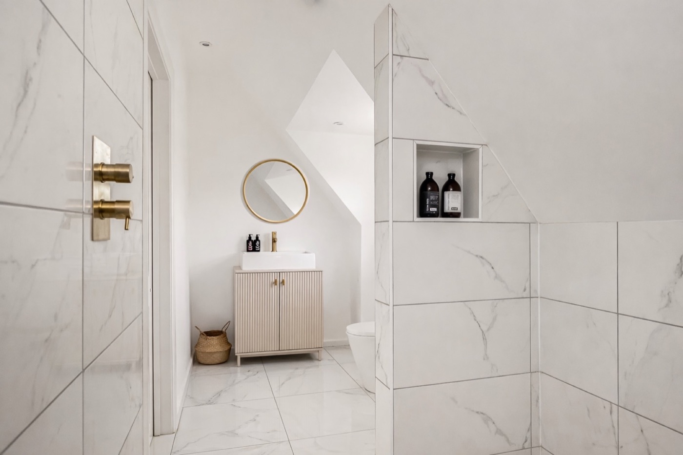Marble-tiled shower room with brass fittings at The Lookout Brighton