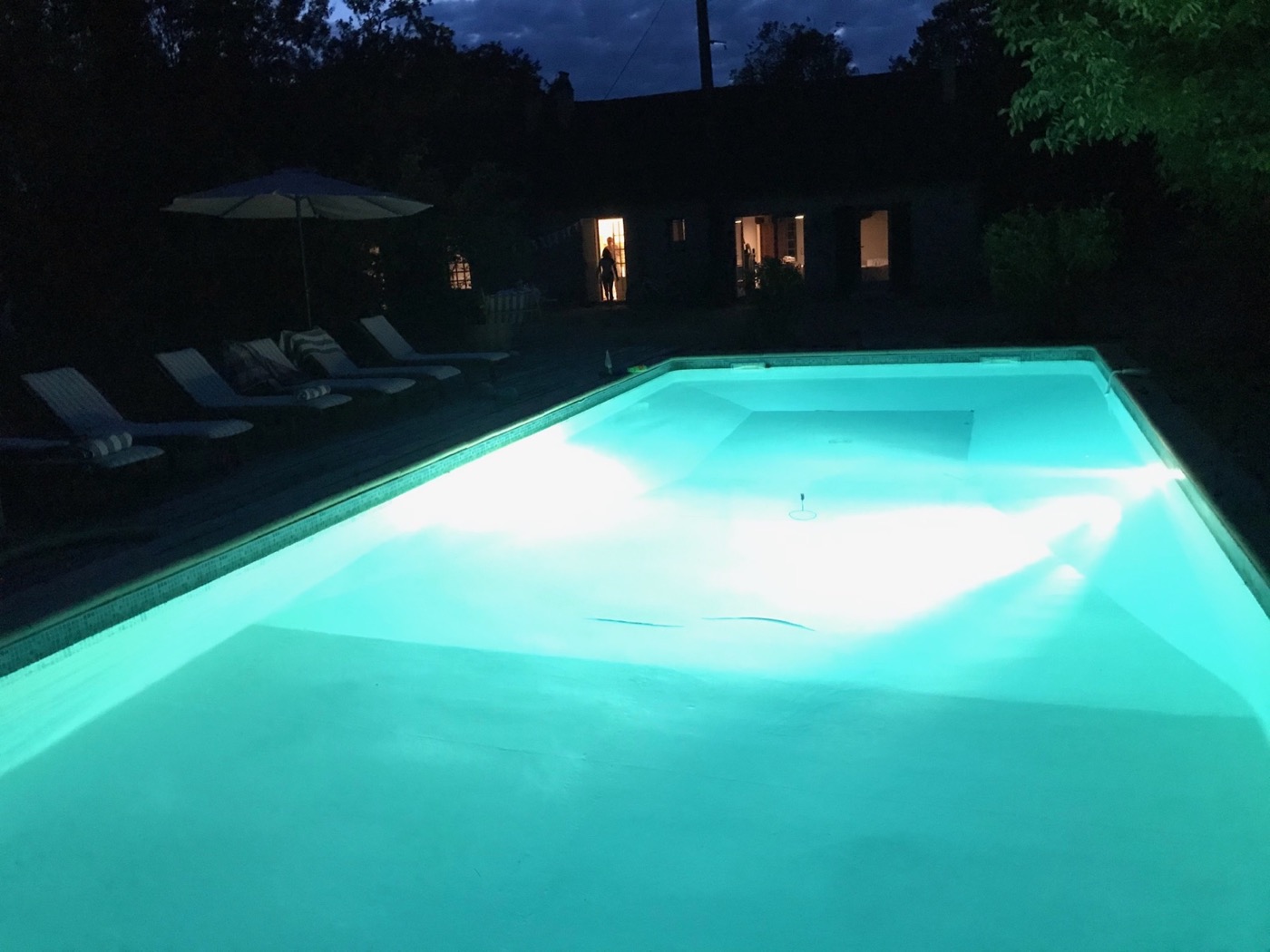 Illuminated private swimming pool after dark