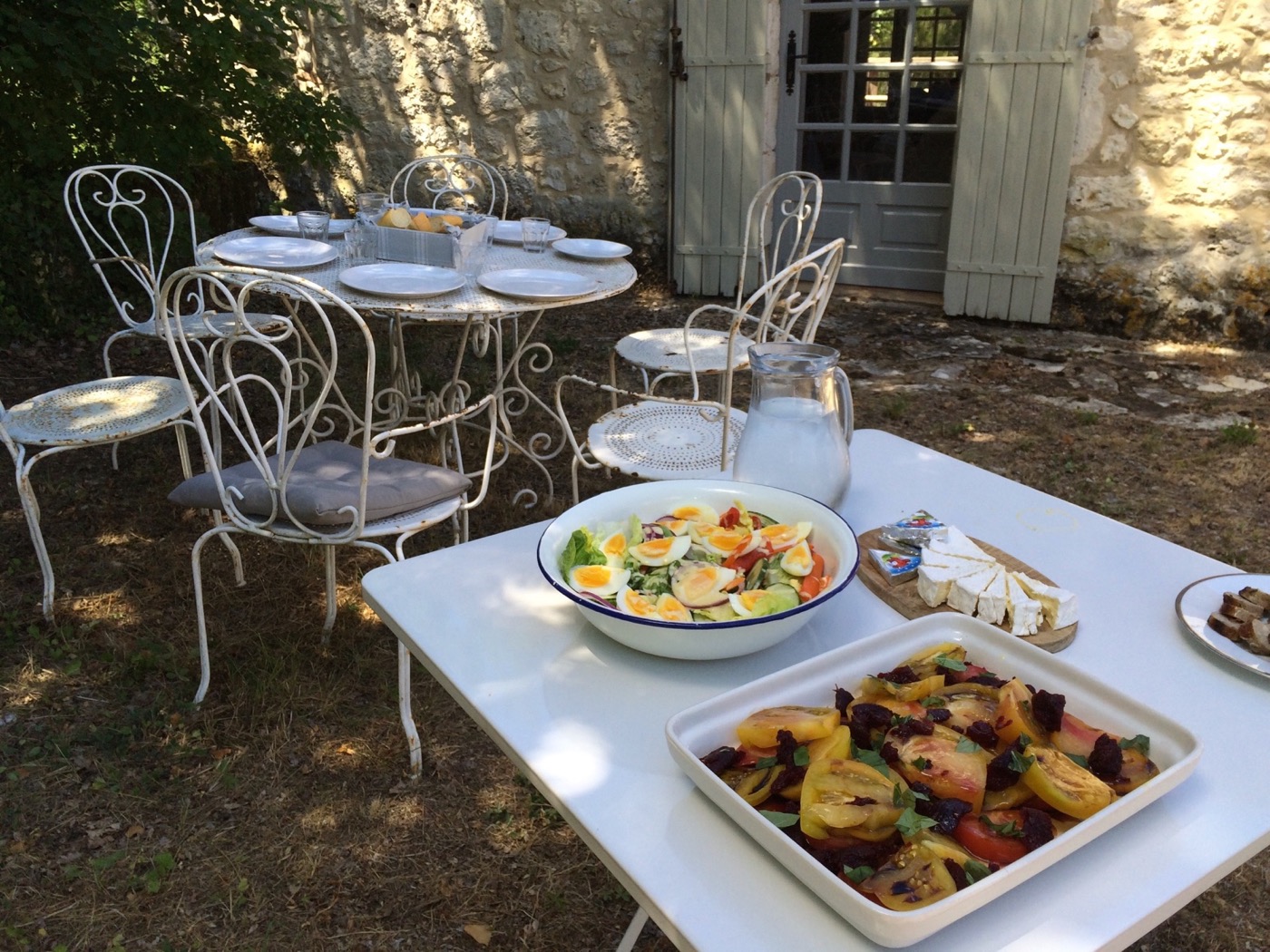 A generous outdoor lunch beside the stone house
